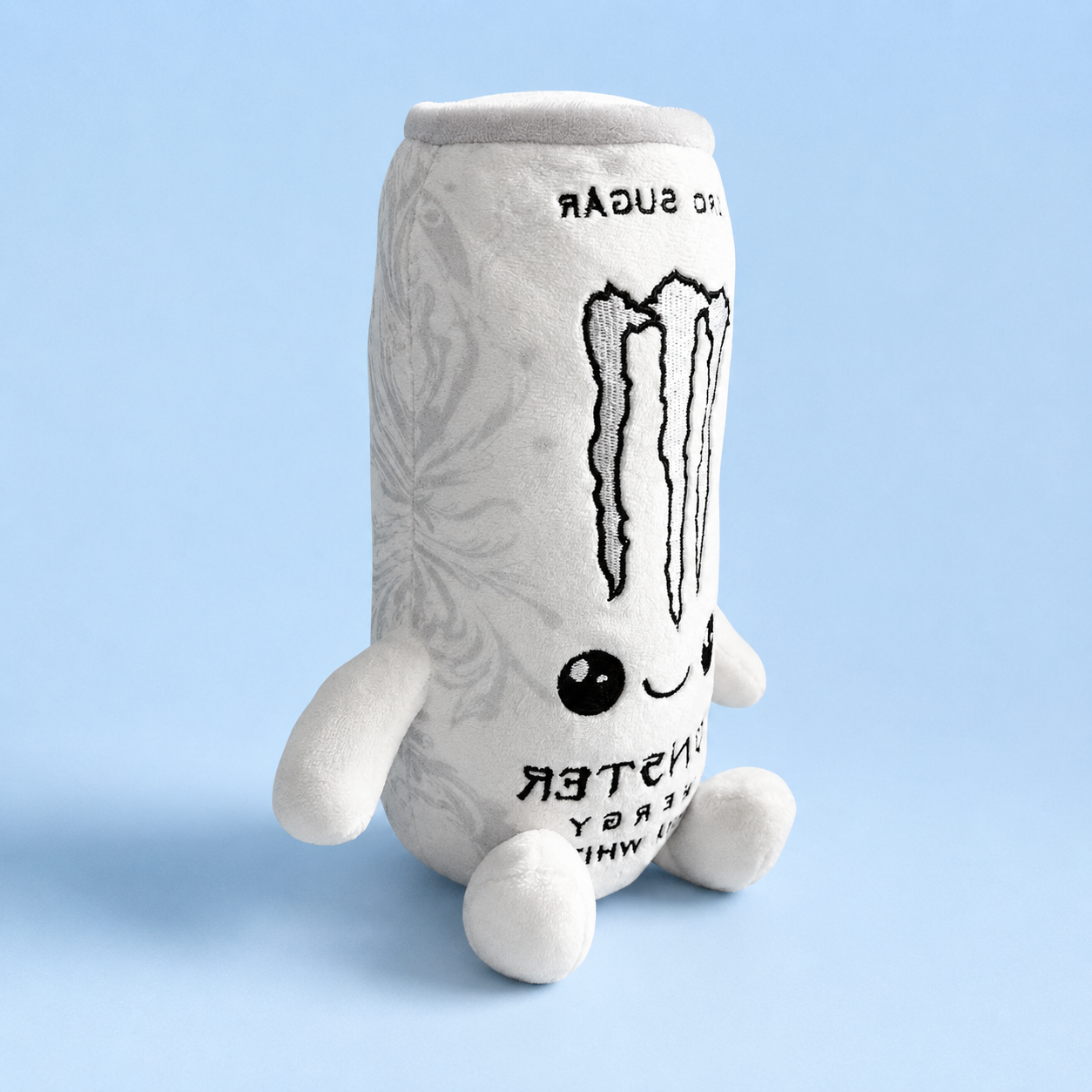 Side view showing the plush’s soft fabric, embroidered graphics, and little arms and feet